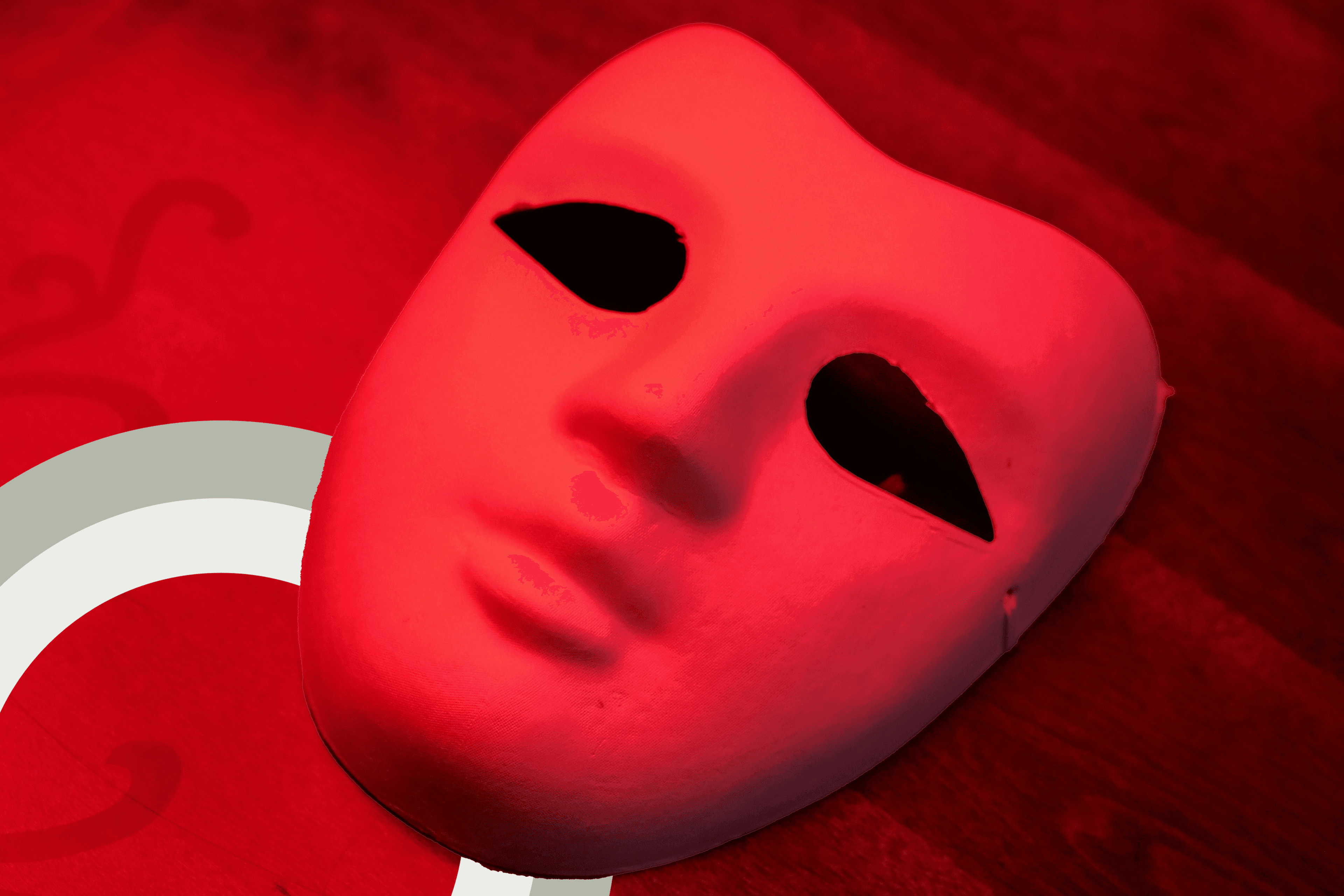A mask on a table under a red light