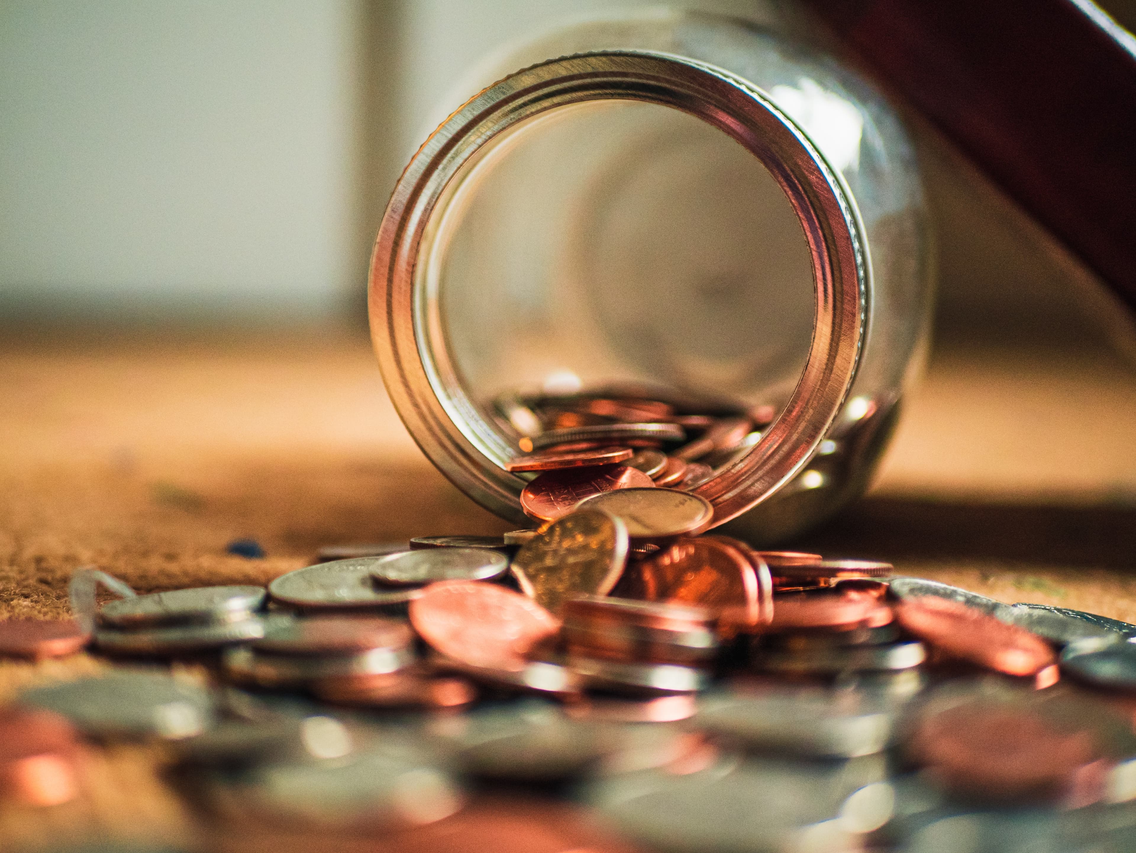 coins-spilling-out-of-jar