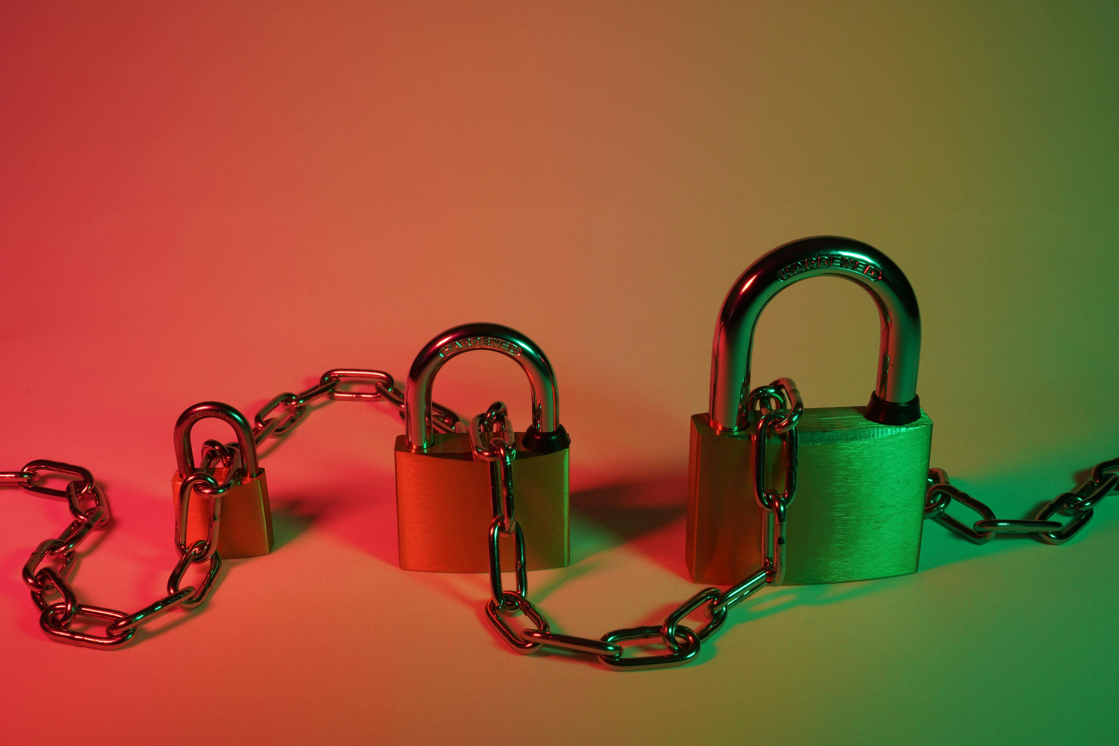 Three padlocks connected by chain to depict security